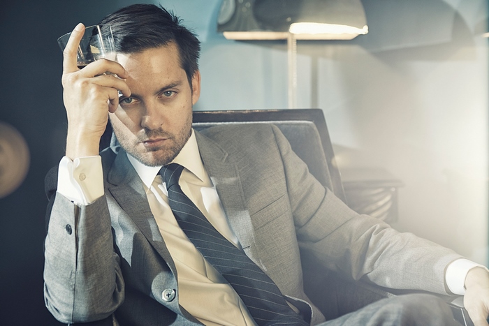 Tobey Maguire holding a glass