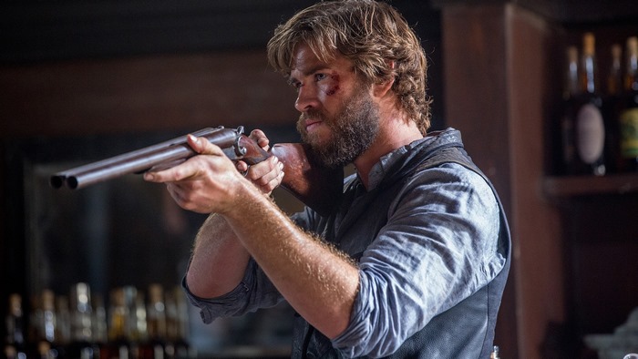 Liam Hemsworth aiming a shotgun