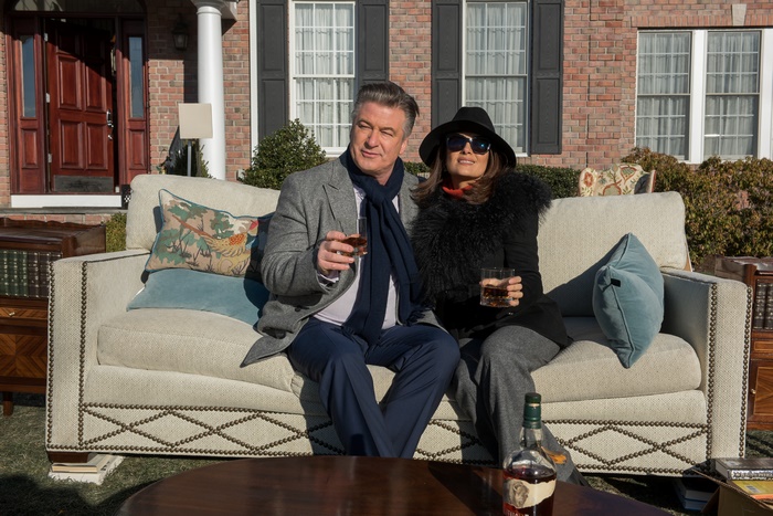 Alec Baldwin and Salma Hayek sitting on a couch