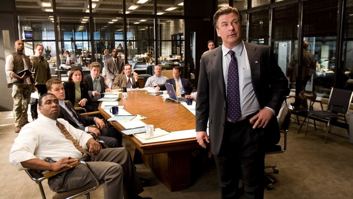 Alec Baldwin in a boardroom meeting