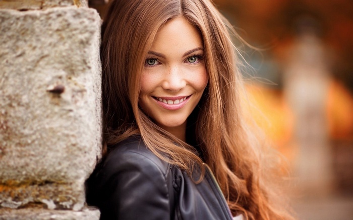 Woman with long brown hair smiling