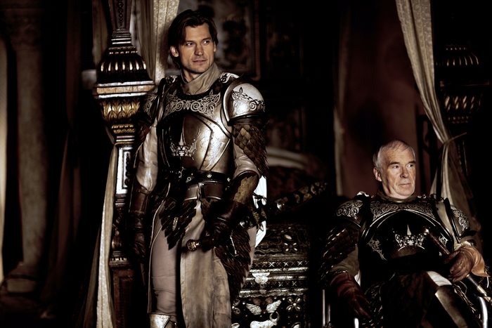 Two men in armor in a dimly lit room