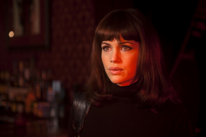 Carla Gugino in a dimly lit bar