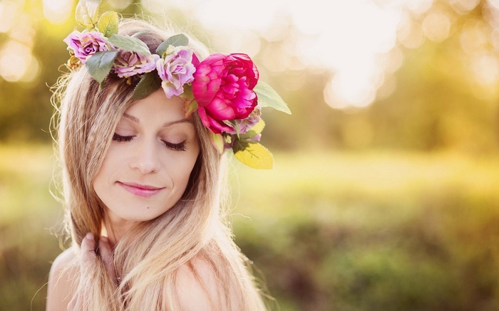 Woman with flower crown in golden hour light