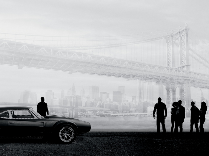 Ludacris and group in front of bridge and city