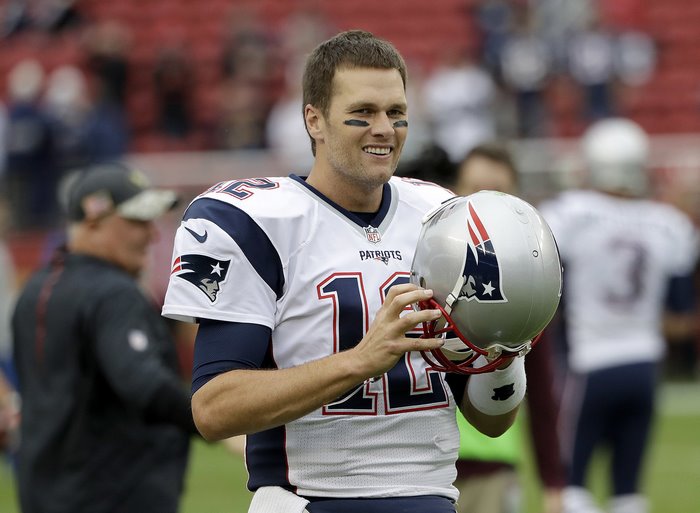 Tom Brady holding a helmet