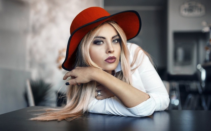 Woman in red hat and white shirt