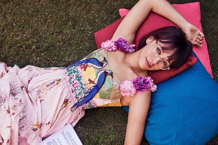 Rashida Jones lying on pillows outdoors
