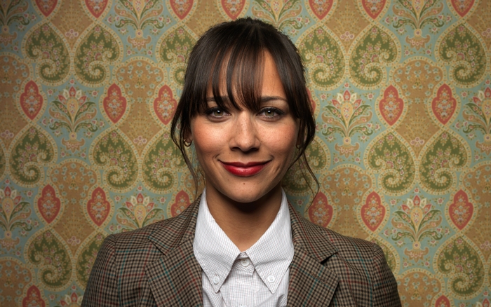 Rashida Jones in front of patterned wallpaper
