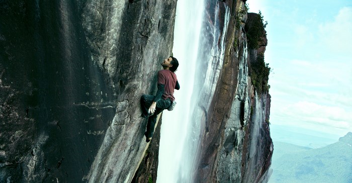 Edgar Ramírez rock climbing near a waterfall