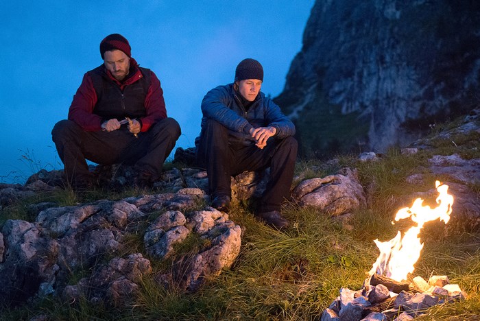 Edgar Ramírez and man by campfire