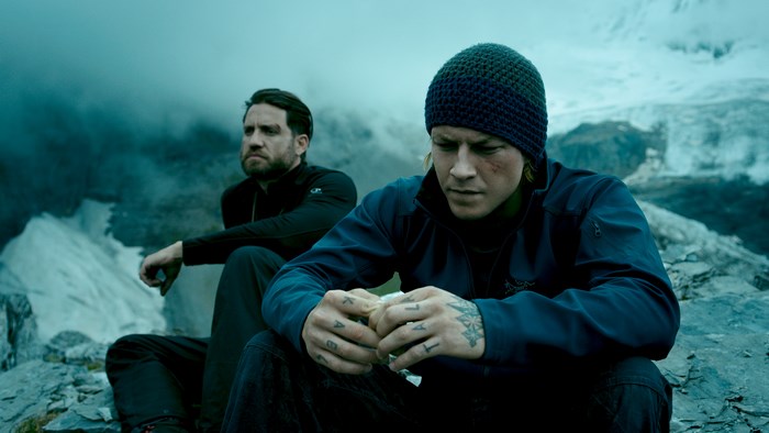 Luke Bracey in a mountainous landscape