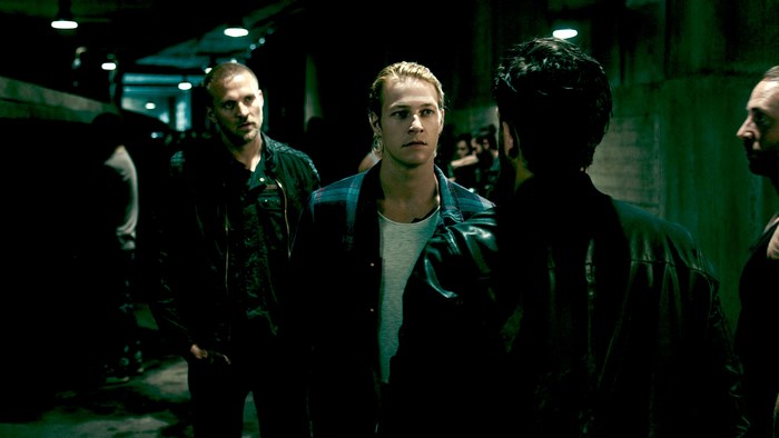 Luke Bracey in a dark alleyway