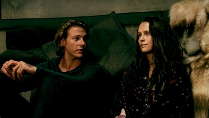 Luke Bracey in a dark room