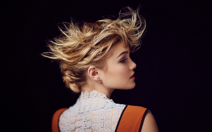 Woman with blonde hair in a white lace top