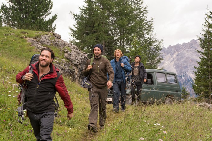 Luke Bracey and friends hiking with a vehicle