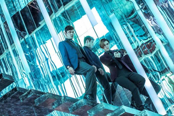 Ruby Rose and two men in a mirrored room