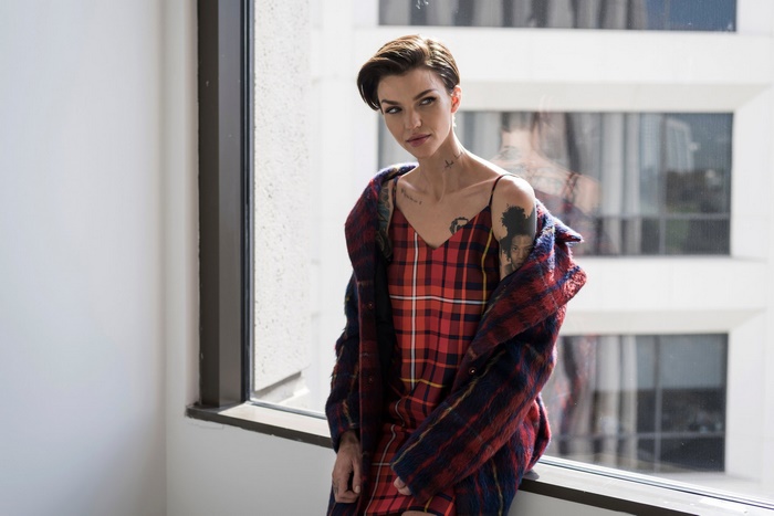 Ruby Rose in a plaid dress and coat