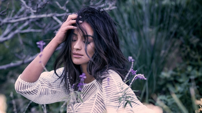Shay Mitchell in a white top with purple flowers