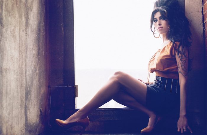 Amy Winehouse sitting by a window