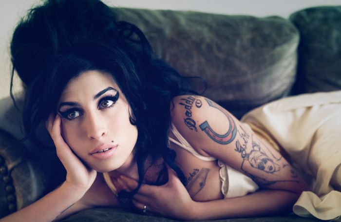 Amy Winehouse lying on a couch