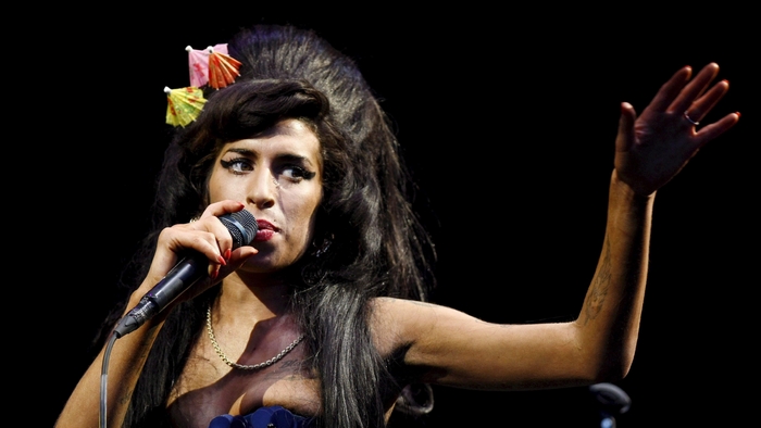 Amy Winehouse performing on stage