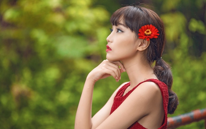 Woman with red flower in hair