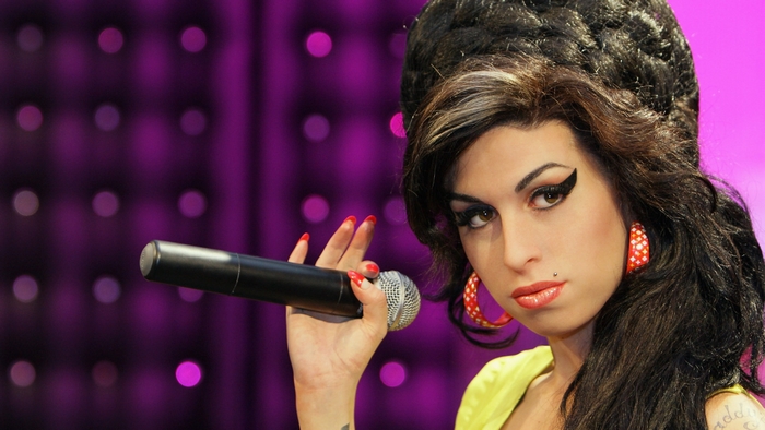 Amy Winehouse holding a microphone
