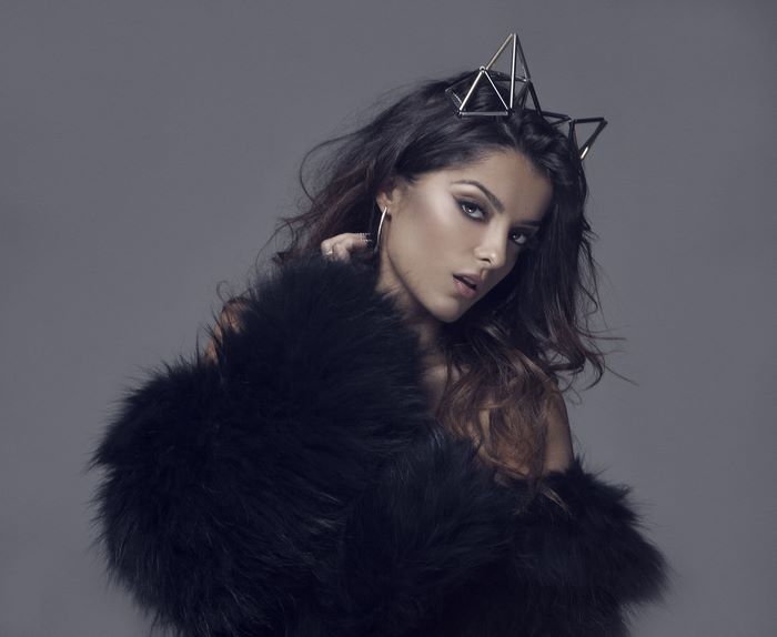 Bebe Rexha wearing a geometric crown and fur coat
