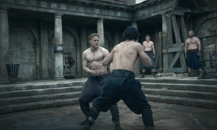 Charlie Hunnam fighting in a courtyard