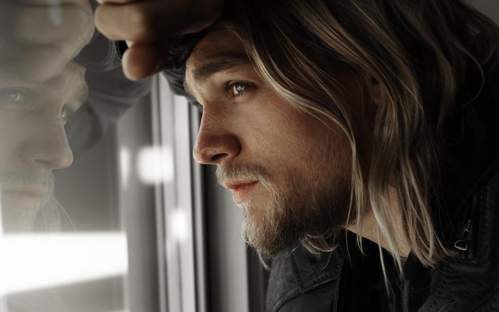 Charlie Hunnam looking out a window