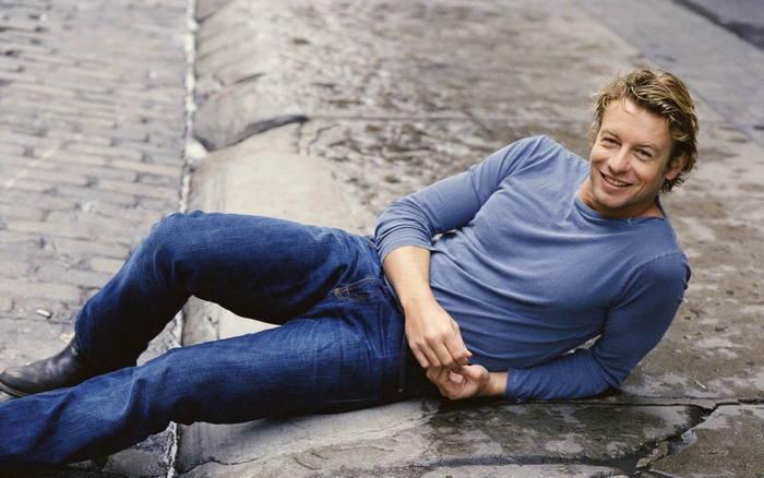 Simon Baker lying on cobblestone