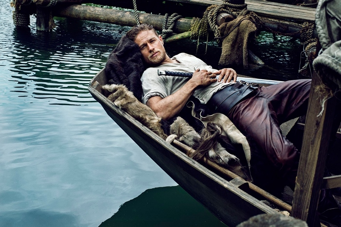 Charlie Hunnam in a boat with furs