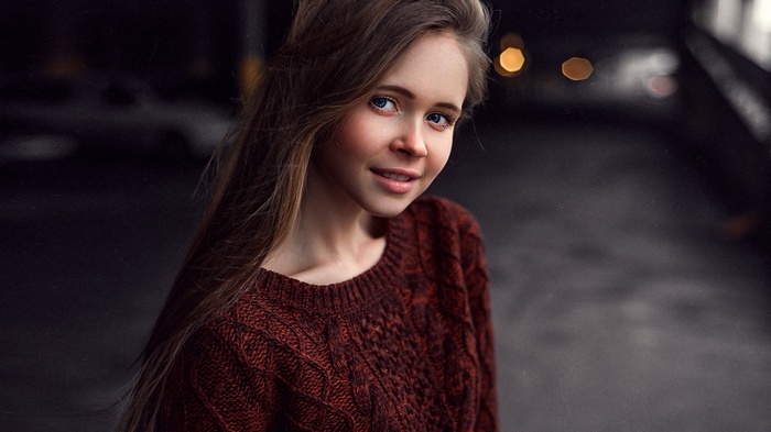 Young woman with blue eyes wearing a red sweater