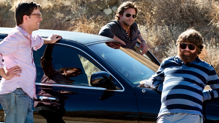 The Hangover: Stu, Phil, and Alan by a car