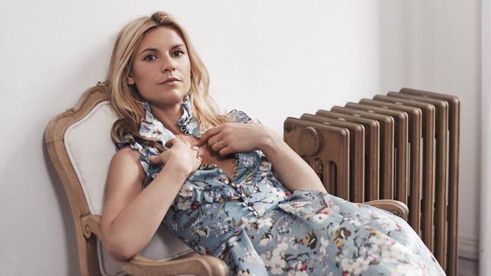 Claire Danes sitting in a chair