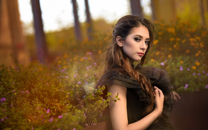 Woman in black dress in a garden