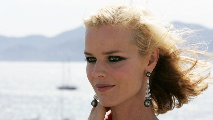 Eva Herzigova on a boat with mountains in the background