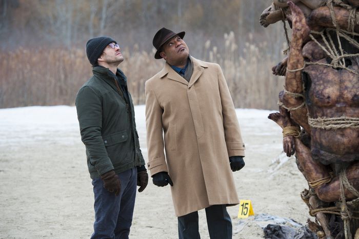 Laurence Fishburne and man examine macabre sculpture