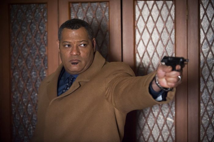 Laurence Fishburne holding a handgun