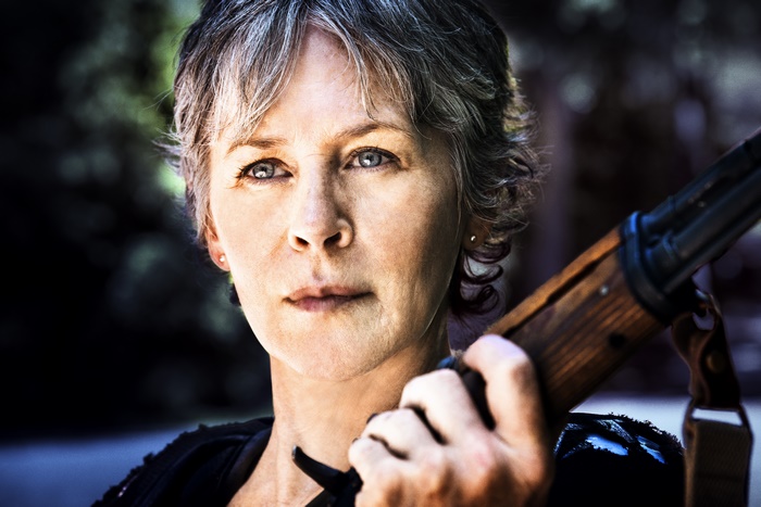 Melissa McBride holding a rifle