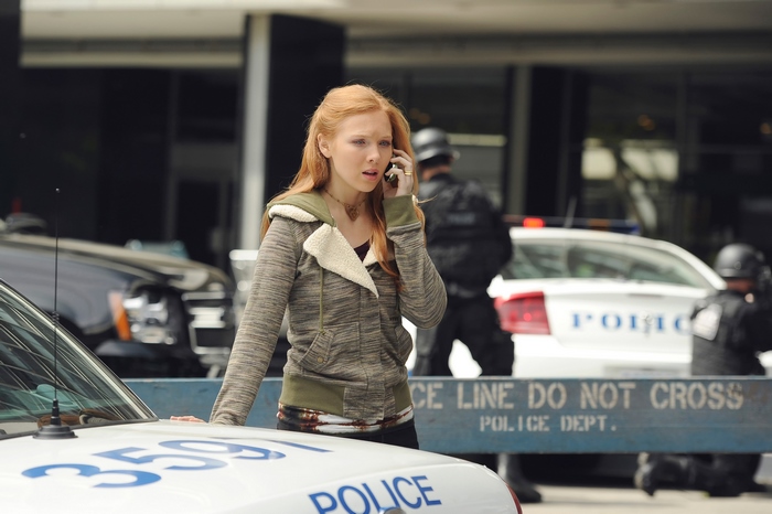 Molly Quinn on the phone near police cars