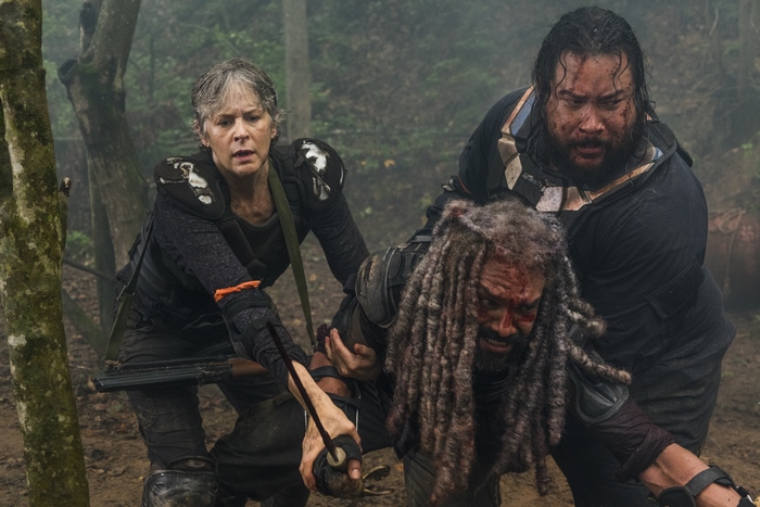 Melissa McBride and others in a forest