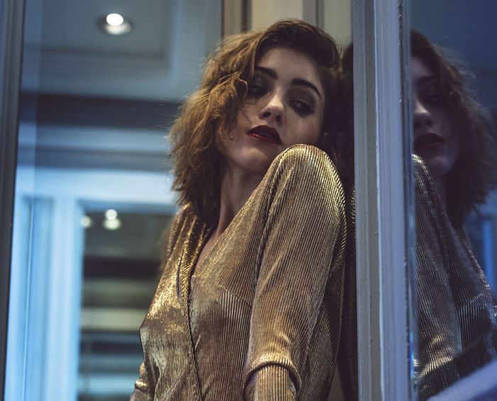 Natalia Dyer in a gold dress