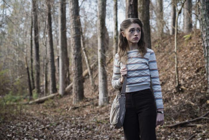 Nancy Wheeler from Stranger Things in a forest