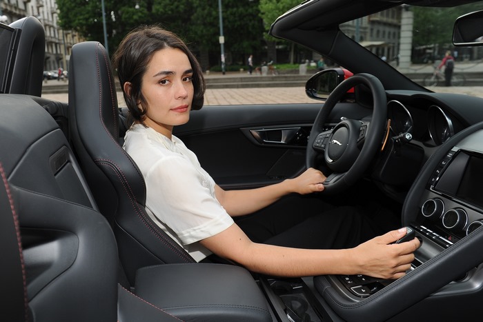 Shannyn Sossamon in a Jaguar convertible