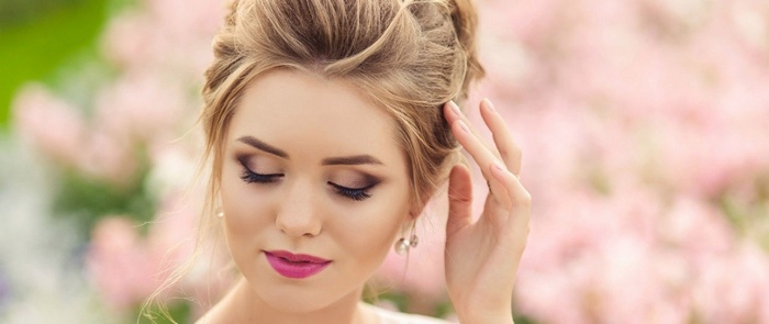 Woman with elegant makeup and hairstyle outdoors