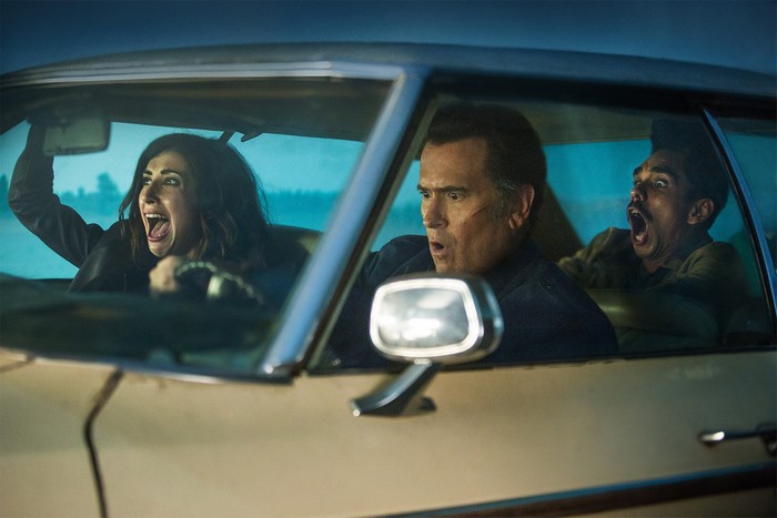 Bruce Campbell and two others in a car
