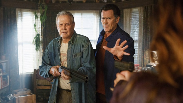 Bruce Campbell and man with shotgun