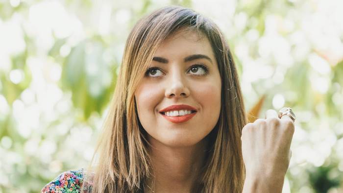 Aubrey Plaza looking up outdoors